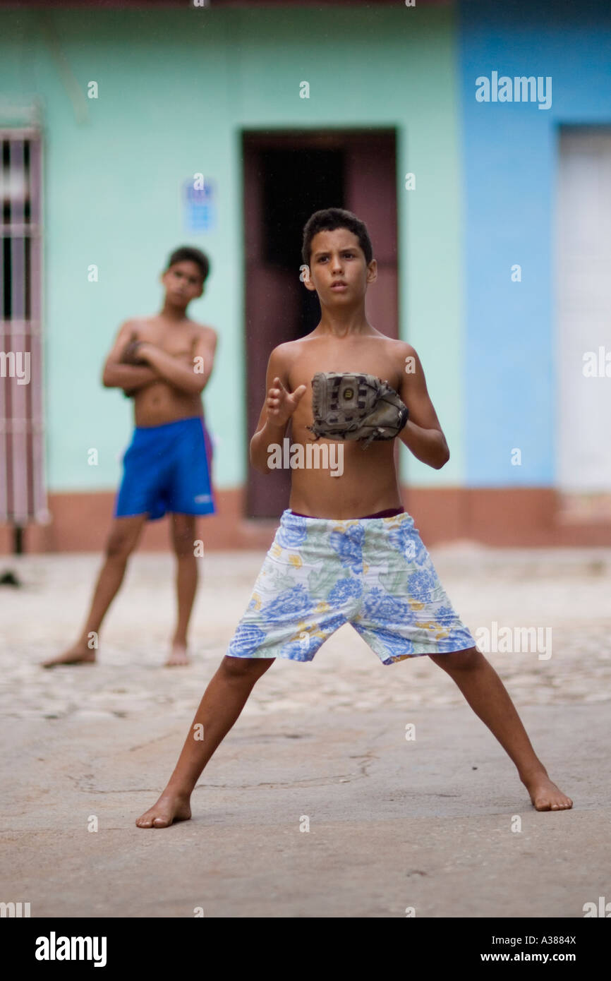A Cuban boy prepares to field a ball in a game of street baseball Stock Photo