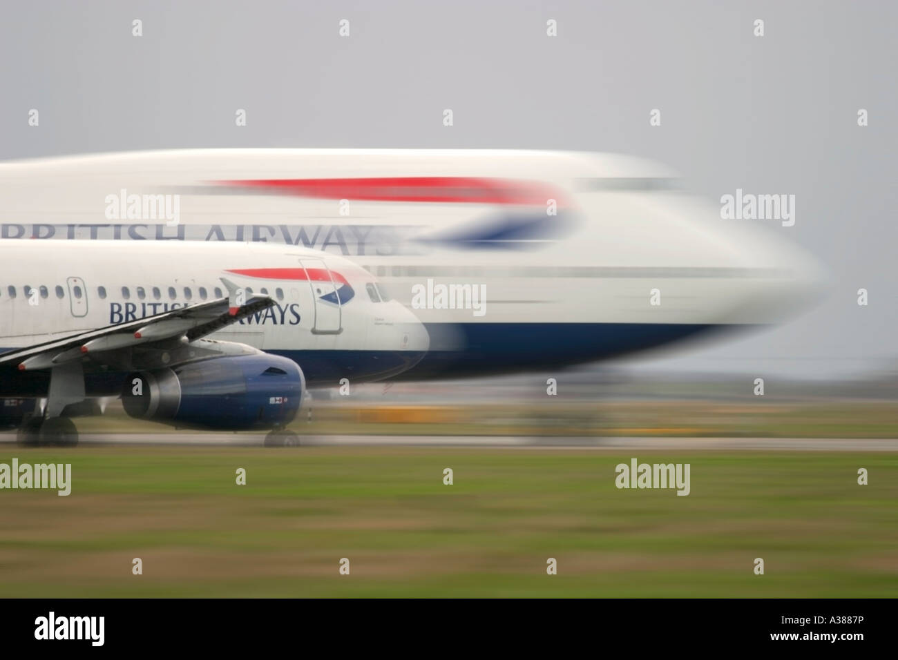 British Airways Airbus A320 and Boeing 747 in queue for departure at London Heathrow Stock Photo