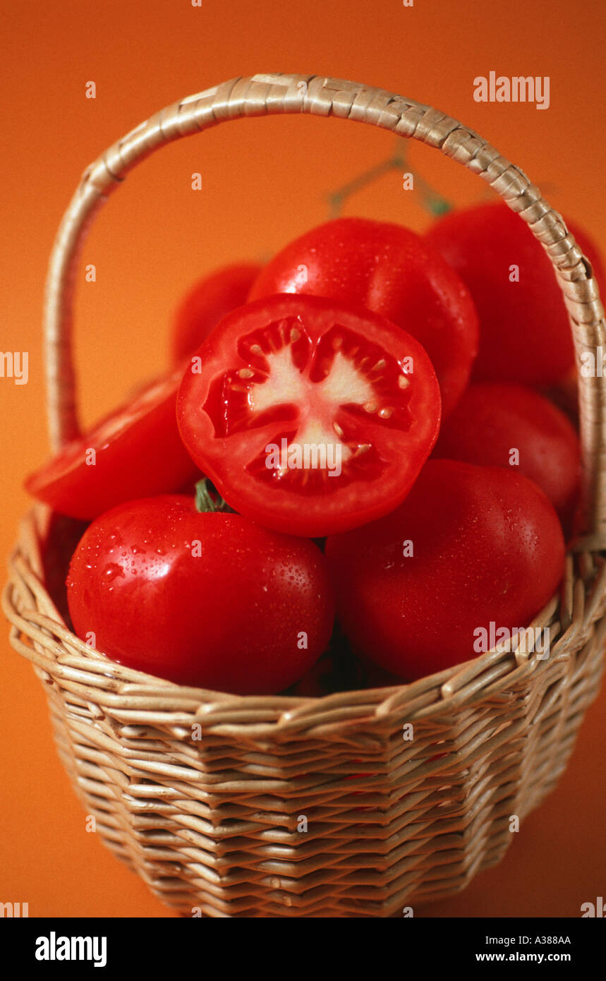Tomatoes and basket Stock Photo - Alamy