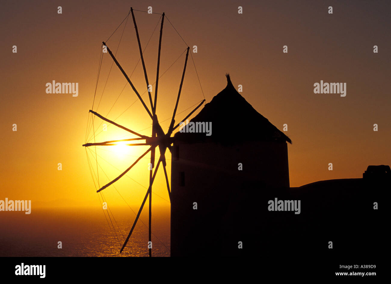 Windmill on the Santorini Island at Sunset, Greece Stock Photo