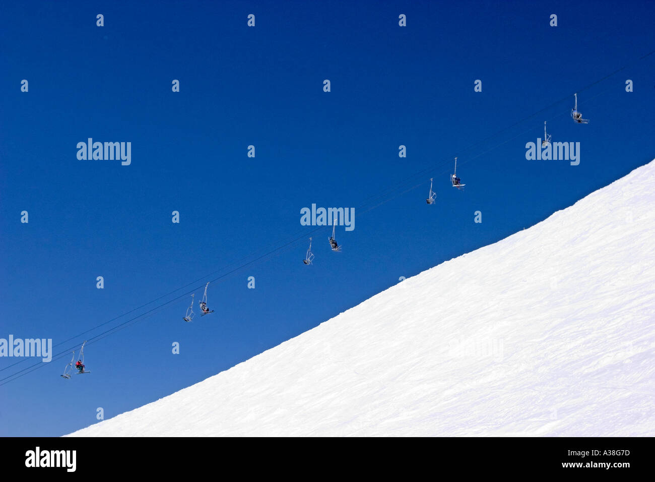 Skiers on chair lift France Stock Photo - Alamy