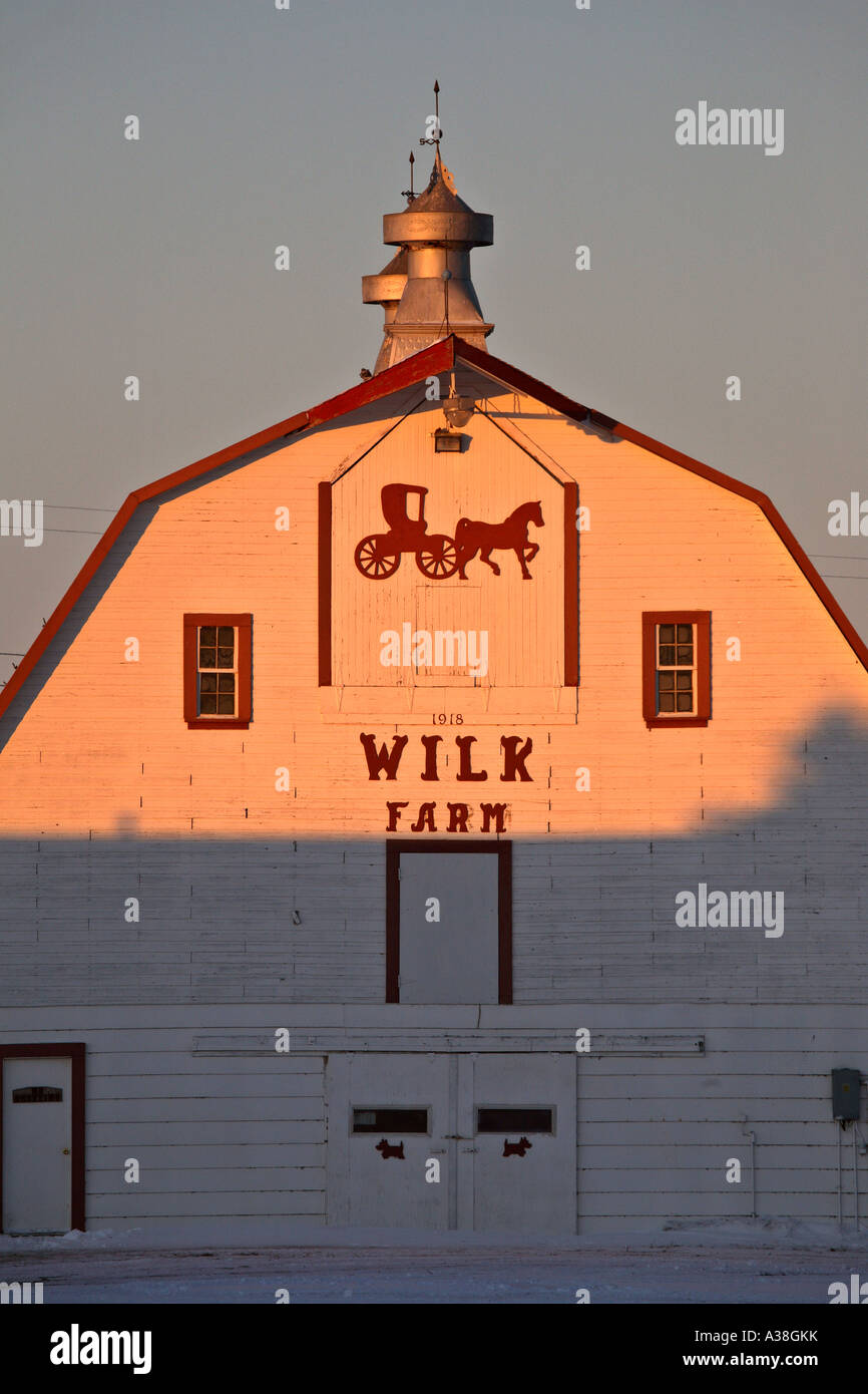 restored white barn half lit by sun Stock Photo Alamy