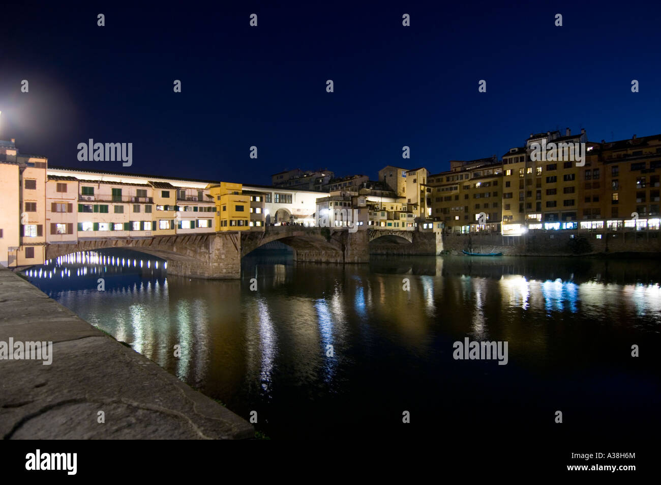 A west side view of the Ponte Vecchio bridge and traditional buildings