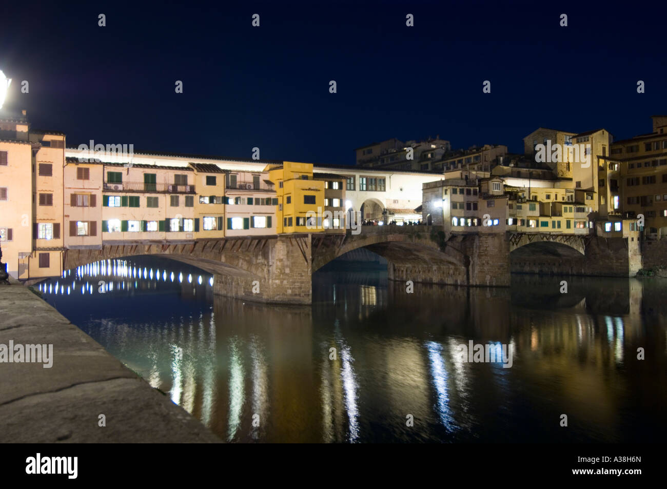 A west side view of the Ponte Vecchio bridge and traditional buildings