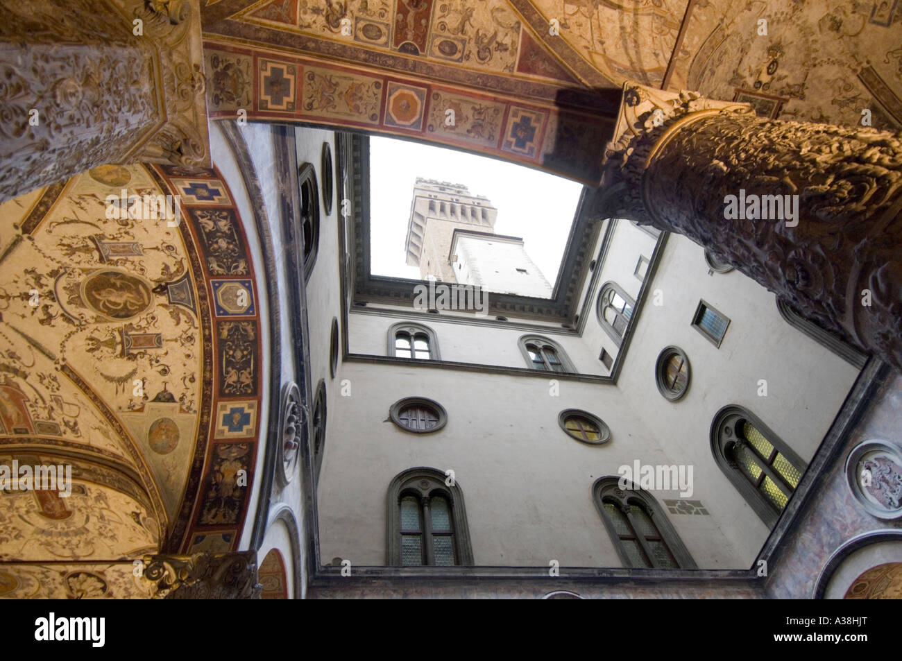 The ornate first courtyard at the entrance of the Palazzo Vecchio with its magnificent ceiling and the tower visible. Stock Photo