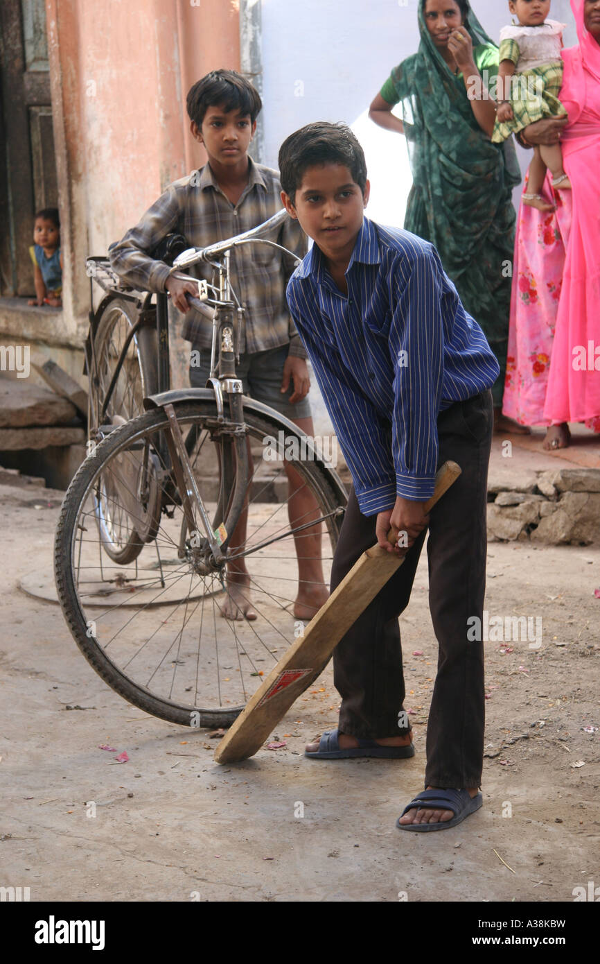 Boys playing cricket in a back street of Udaipur, Southern Rajasthan, India Stock Photo