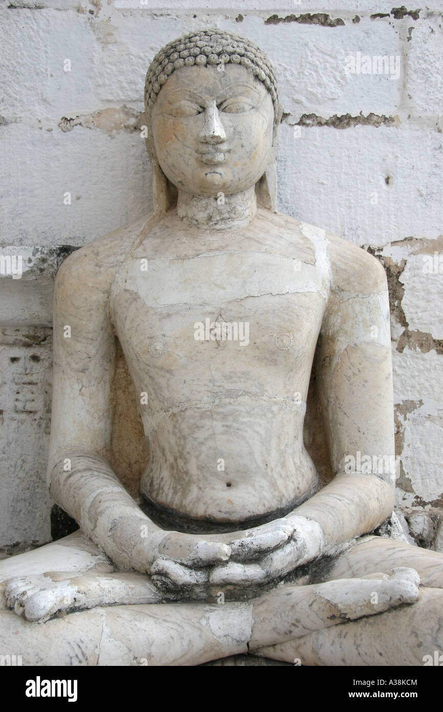 White marble Buddha statue carved in the lotus position at the jain temple in Udaipur, Southern Rajasthan, India Stock Photo