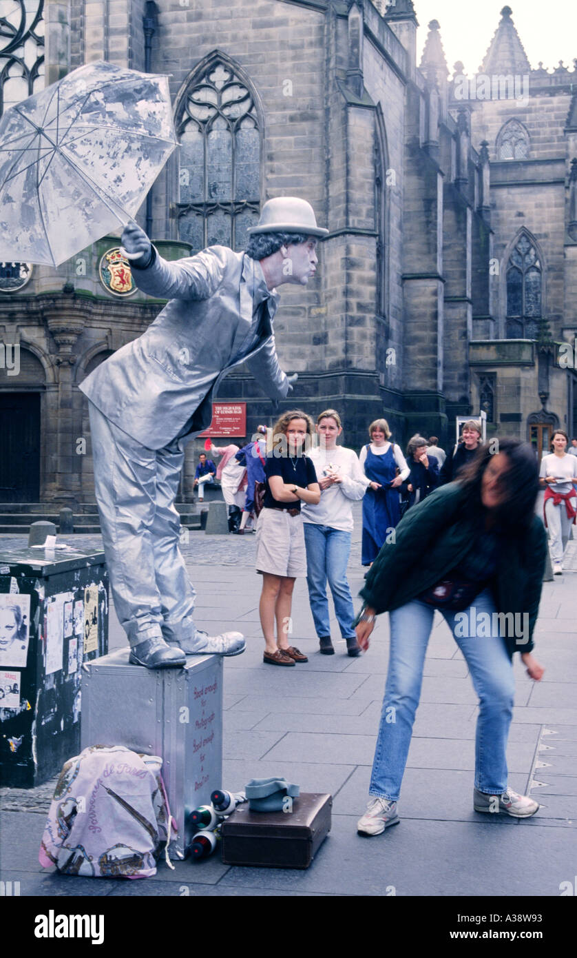 Edinburgh Festival Scotland. Busker living statue performing on Royal Mile outside St Giles Cathedral dressed as Charlie Chaplin Stock Photo