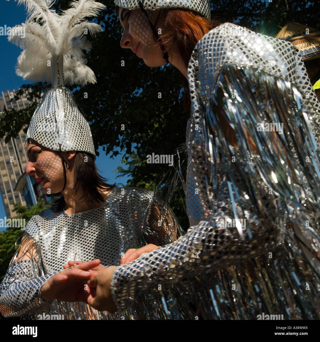 Women dressed up in exotic silver clothes for a street carnival South Bank London England UK (2006) Stock Photo