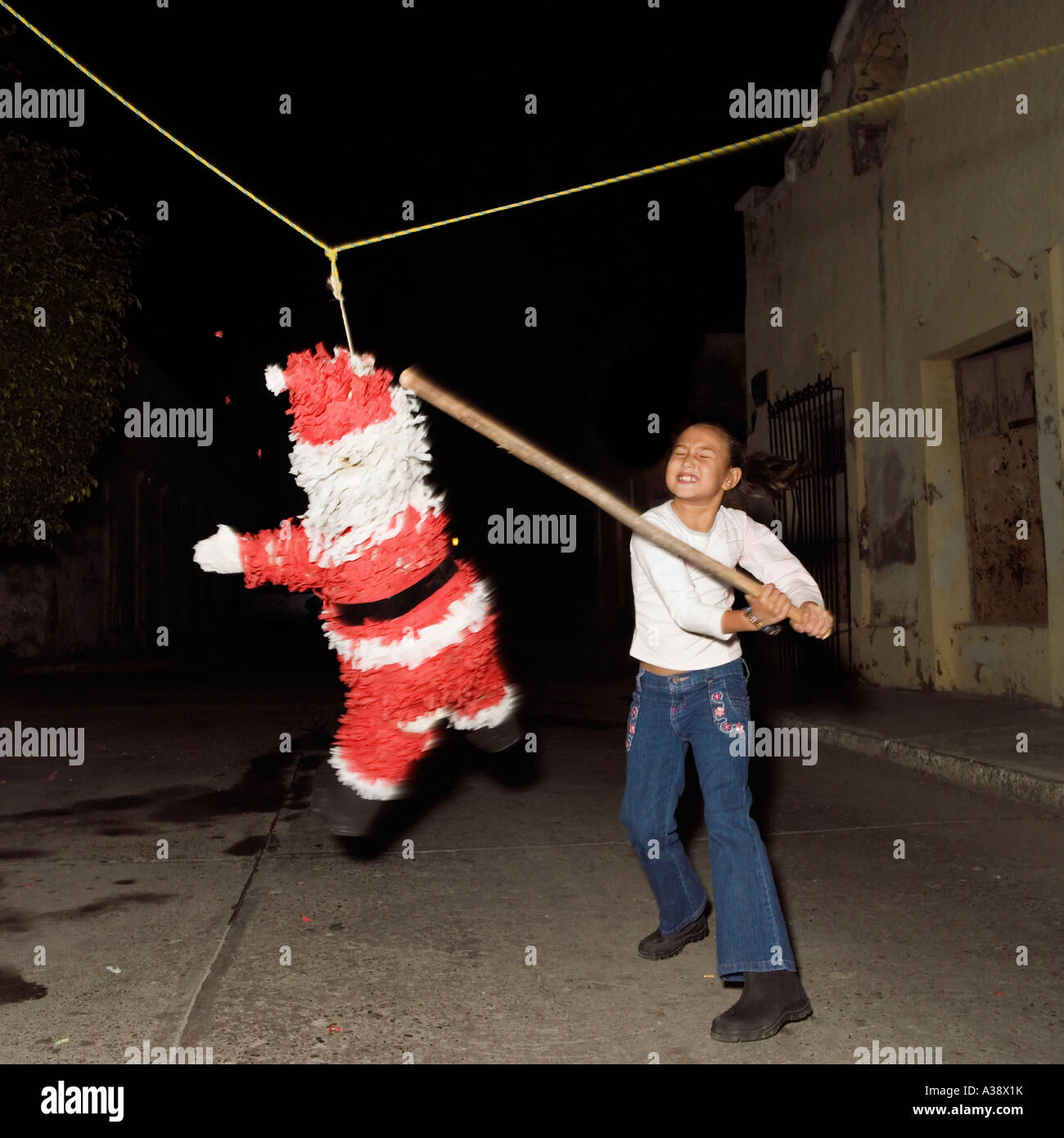 Kids hitting pinata in mexico hi-res stock photography and images - Alamy
