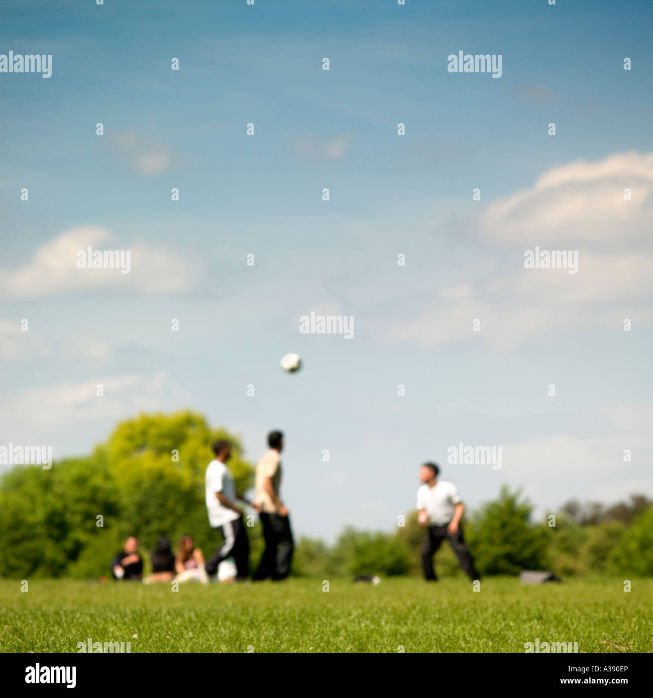 playing football in the Regent's park summer London soft focus No model release required, faces not in focus, unrecognizable Stock Photo