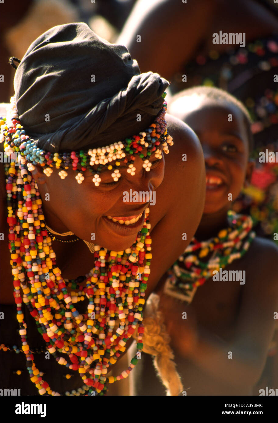 South African  Zulu woman dancer with son, in traditional costume with beads and necklaces Stock Photo