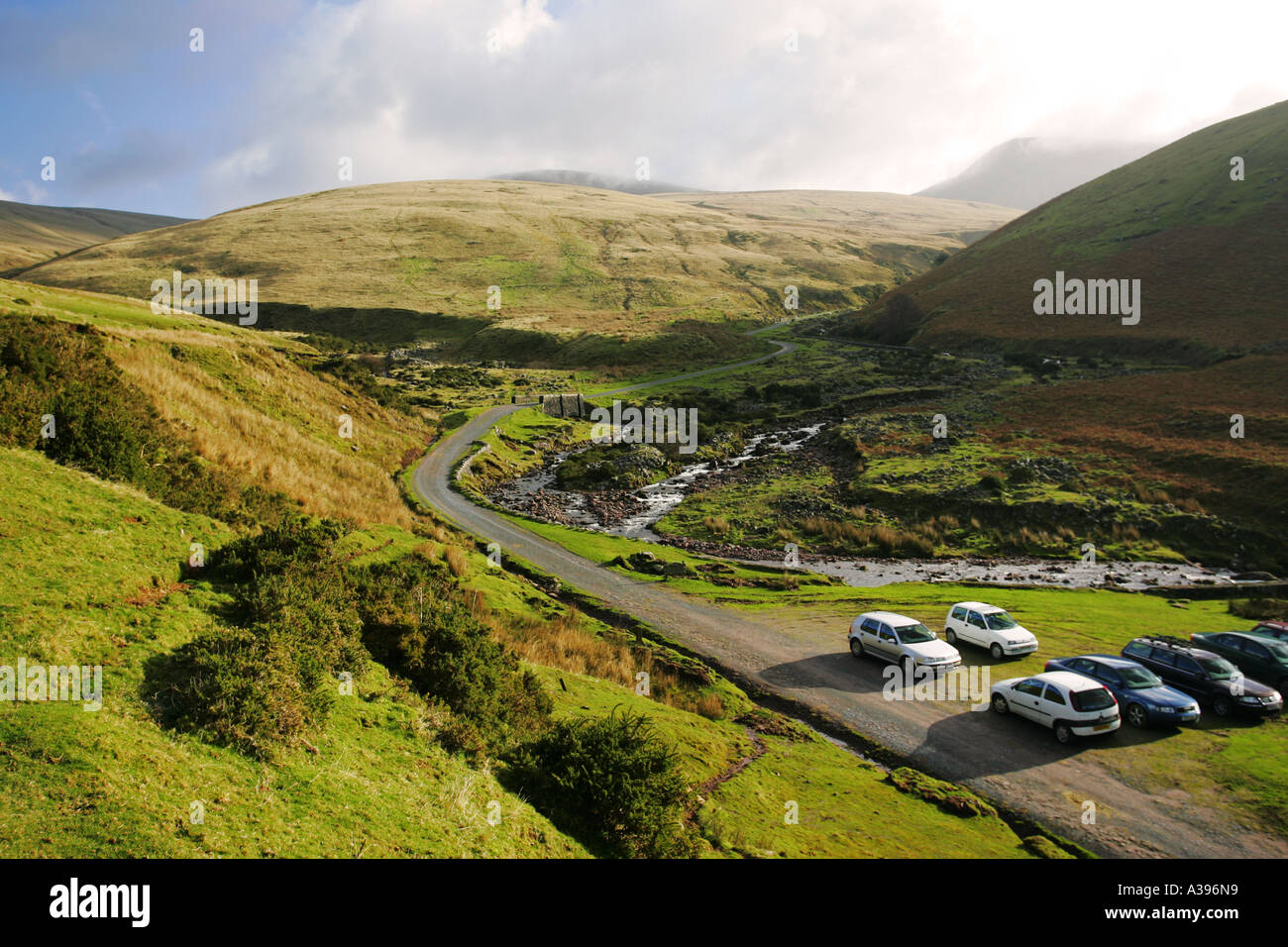 Tourist car park in green valley at start of walk to Llyn y Fan Fach lake Llanddeusant Brecon beacons National Park Mid Wales UK Stock Photo