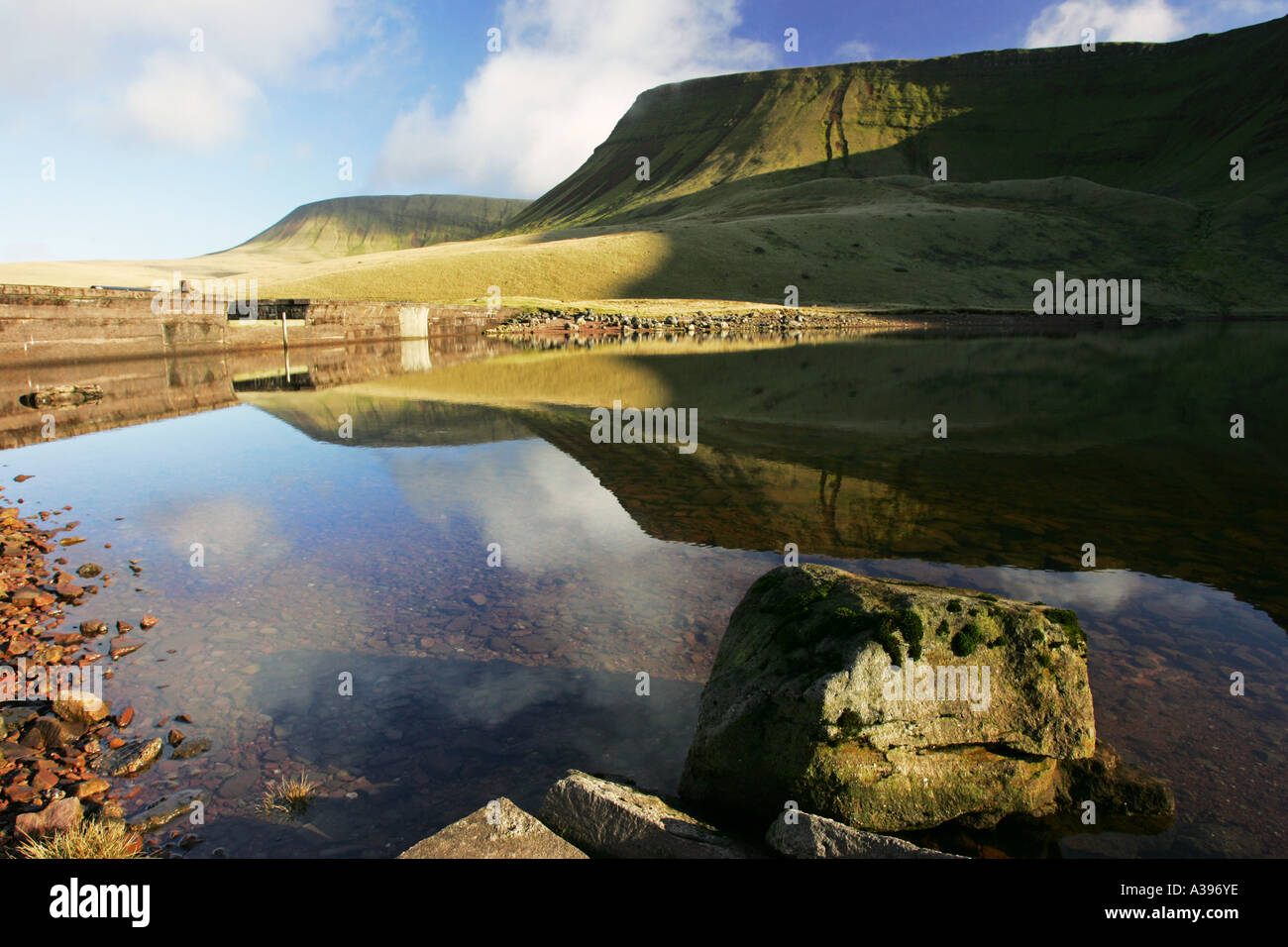 The Carmarthen Fan reflected in Llyn y Fan Fach magic lake, a popular tourist attraction Brecon Beacons national park Mid Wales Stock Photo