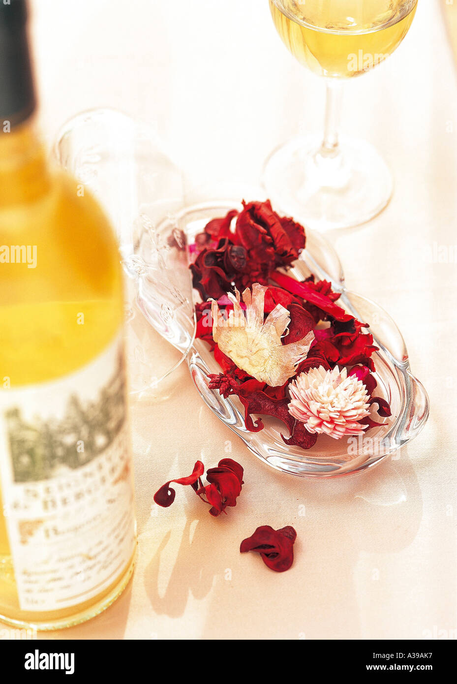 A wine bottle with decorated flower leaf in the flower bowl. Stock Photo