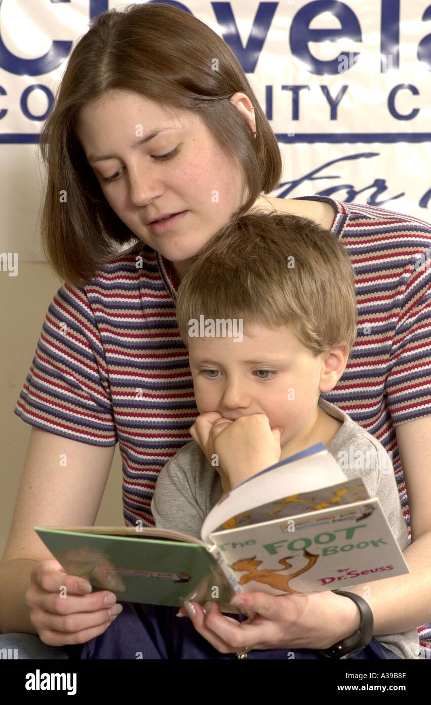 Teacher reading to preschool child Stock Photo - Alamy