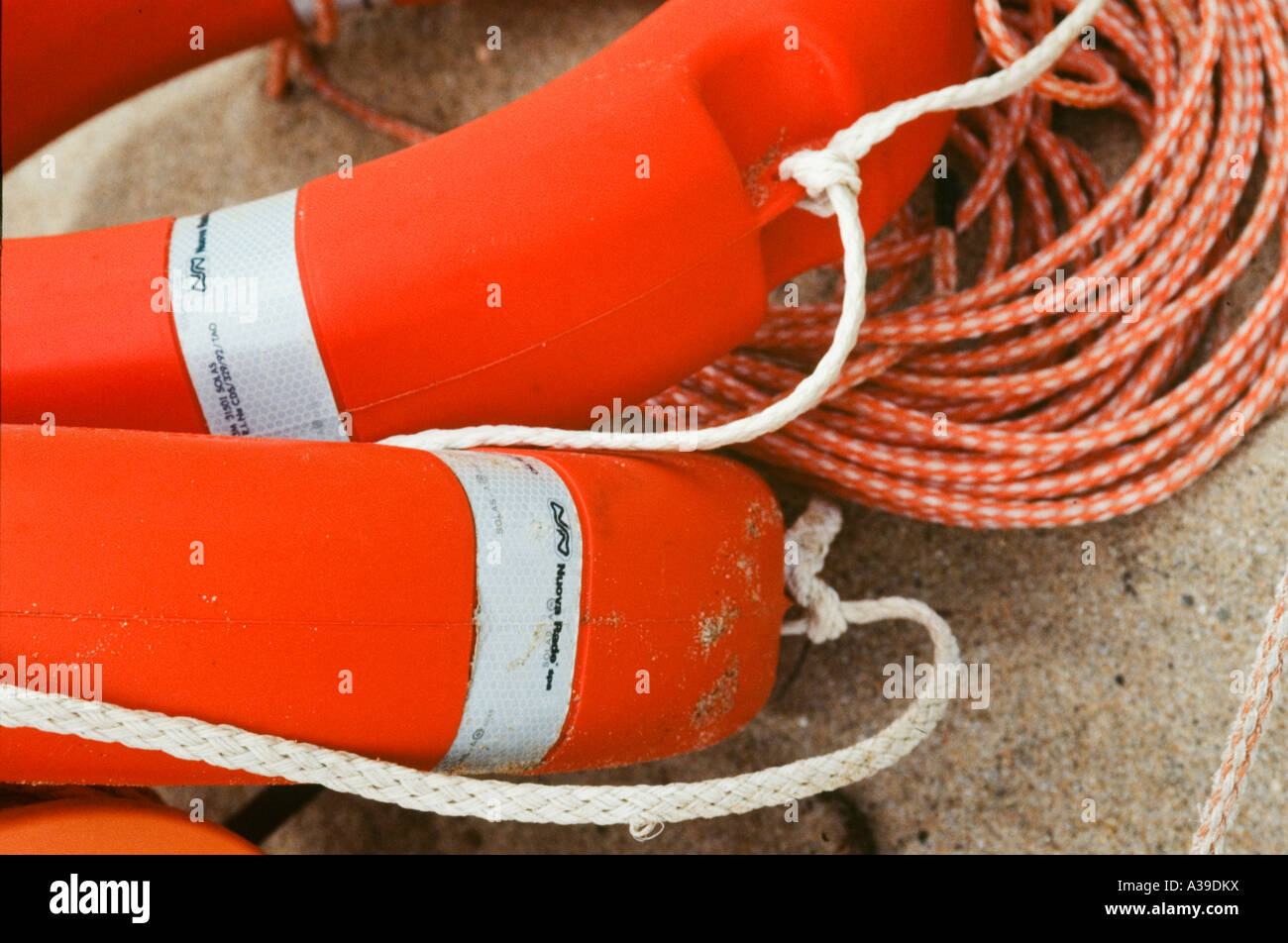 life jackets, ropes, orange, white, beach, sand, rescue, close up Stock