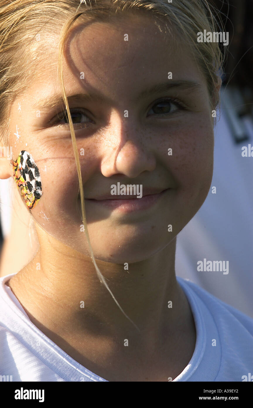 smiling girl with soccer face paint Stock Photo Alamy