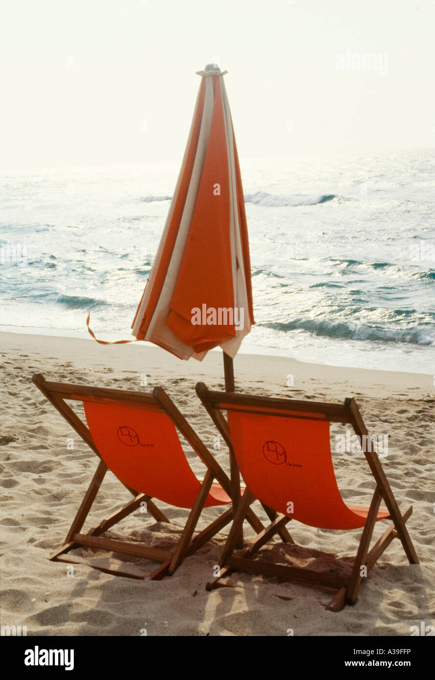 beach, Sardinia, Italy, Europe, sea, moved, beach, wind, beach umbrella, two beach chairs, orange, close, wave, vertical, summer Stock Photo