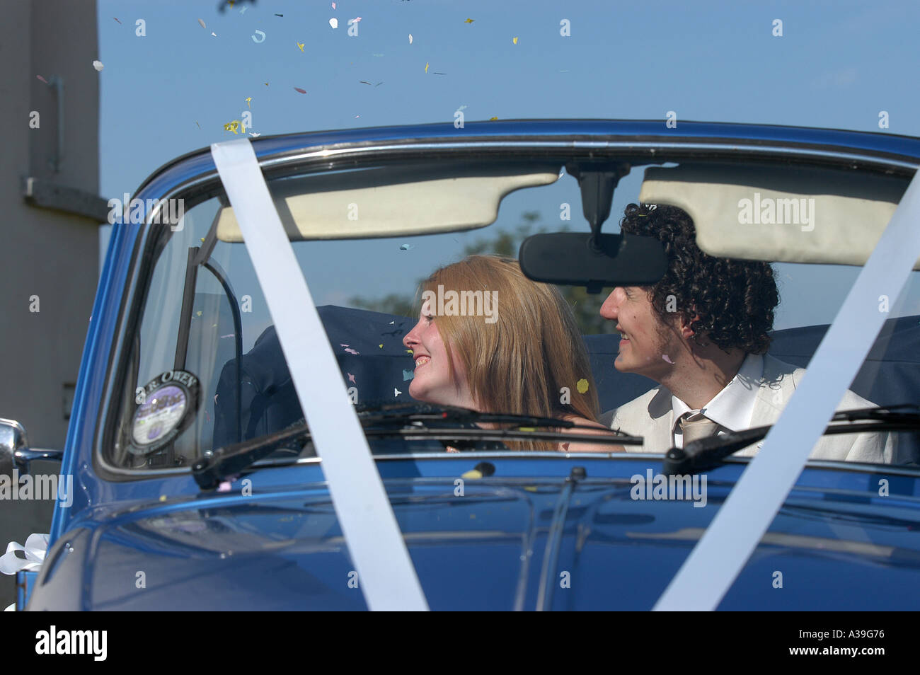 A wedding car and confetti scene Stock Photo Alamy