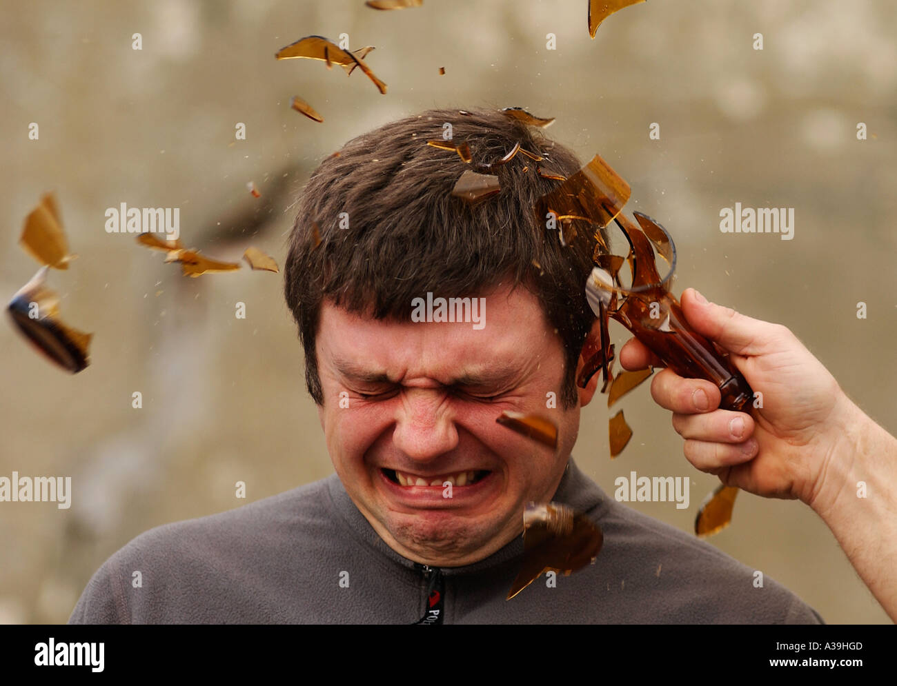 Breaking a glass beer bottle over a person s head Stock ...