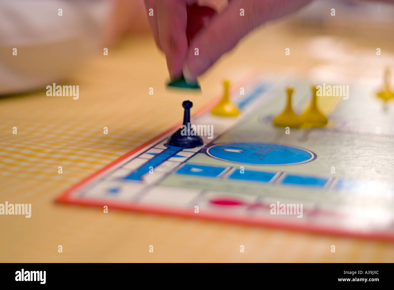 Capturing another players piece playing board game Sorry Stock Photo