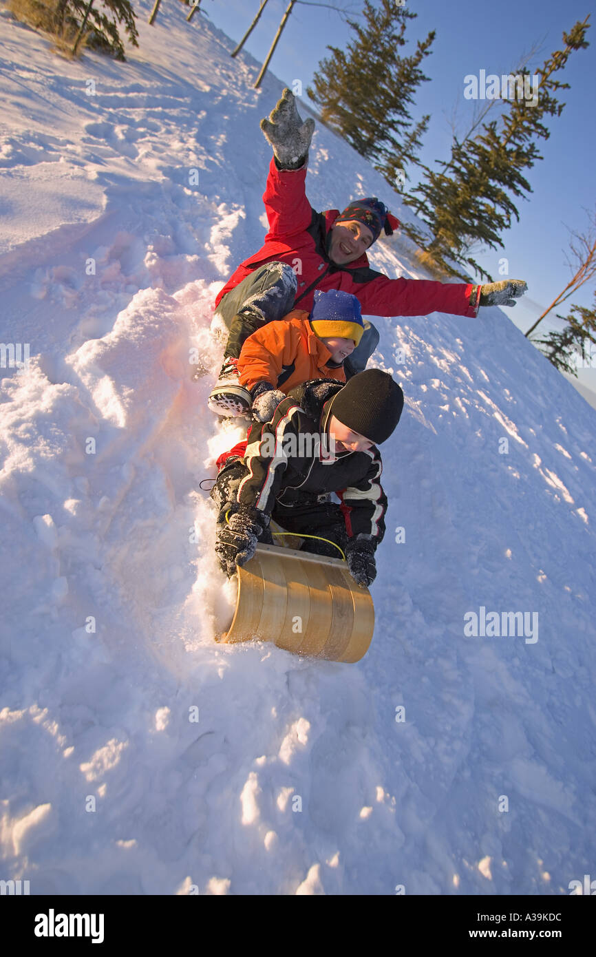 Family on toboggan Stock Photo Alamy