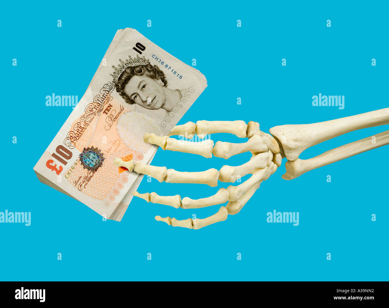 10 ten pound notes held in left skeleton hand Stock Photo