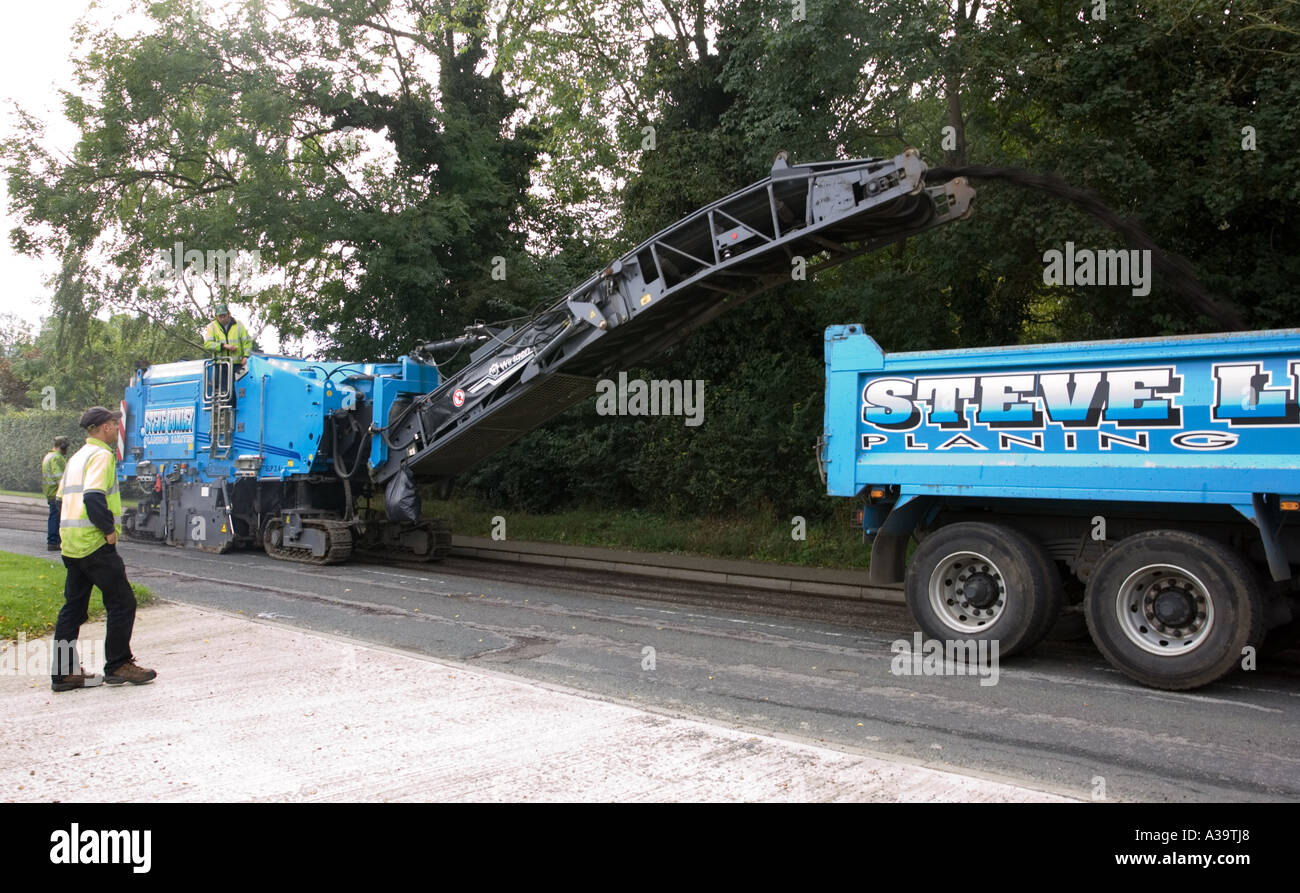 asphalt being planed (removed) before resurfacing a road Stock Photo