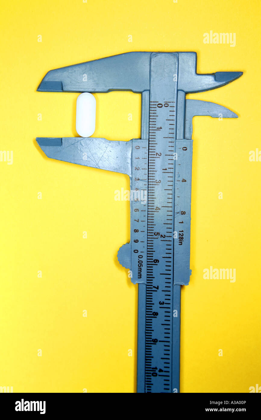 Pill in calipers Stock Photo Alamy