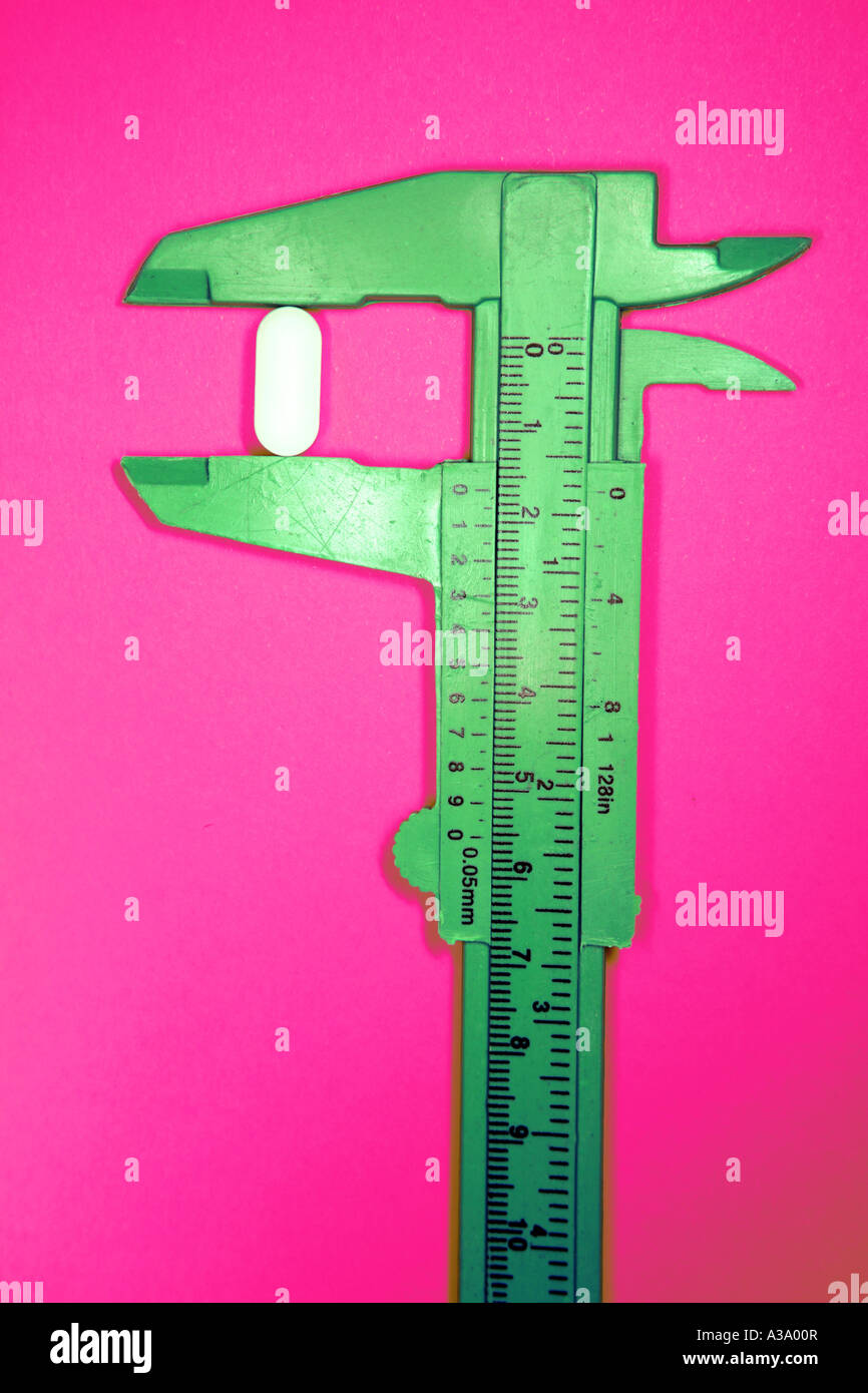 Pill in calipers Stock Photo Alamy