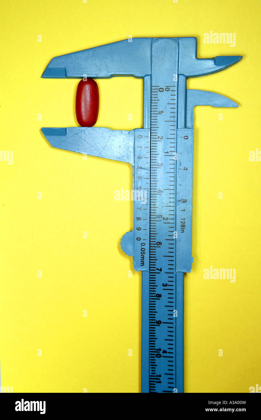 Pill in calipers Stock Photo Alamy