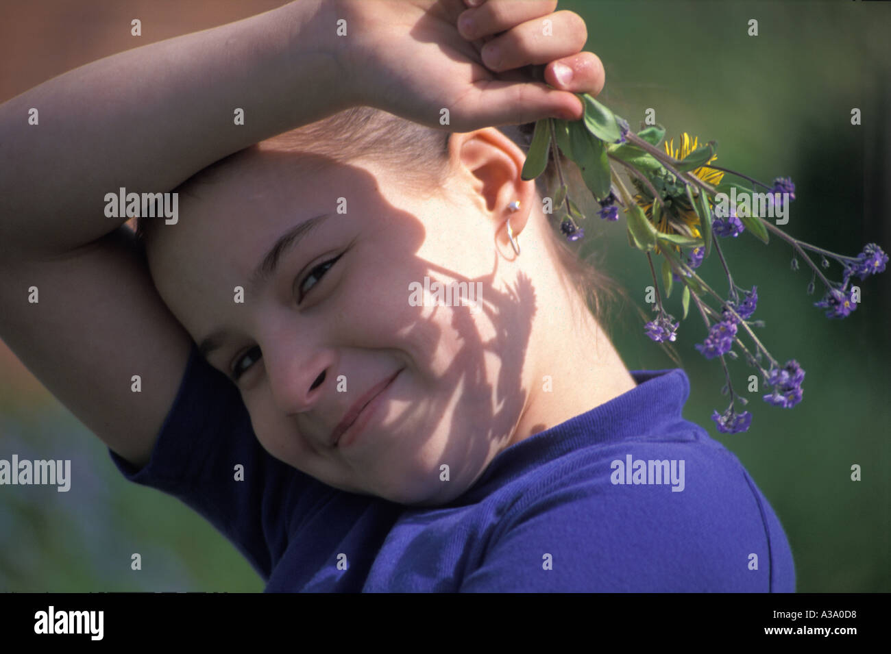 Smiling Girl Holding Flowers Stock Photo - Alamy