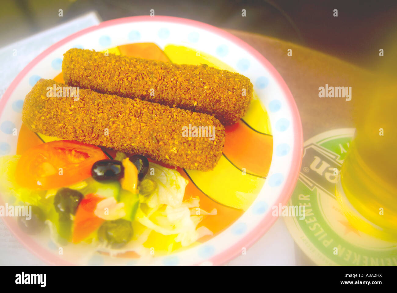 Local delicacy called croquettes, with beer in "Amsterdam" Cafe given a soft photographic touch Stock Photo