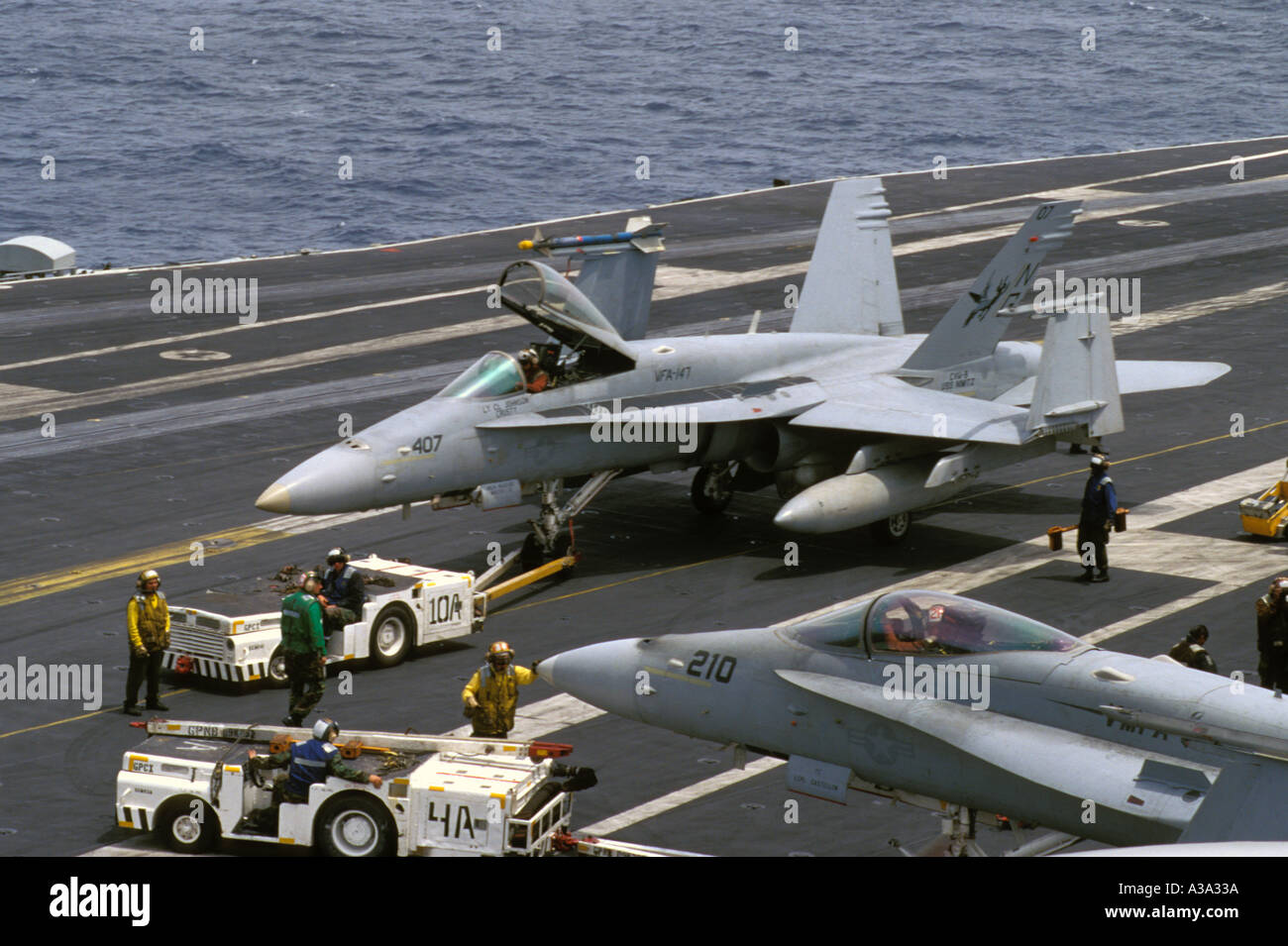 f-a-18-hornet-being-towed-on-deck-of-aircraft-carrier-nimitz-cvn-68-A3A33A.jpg