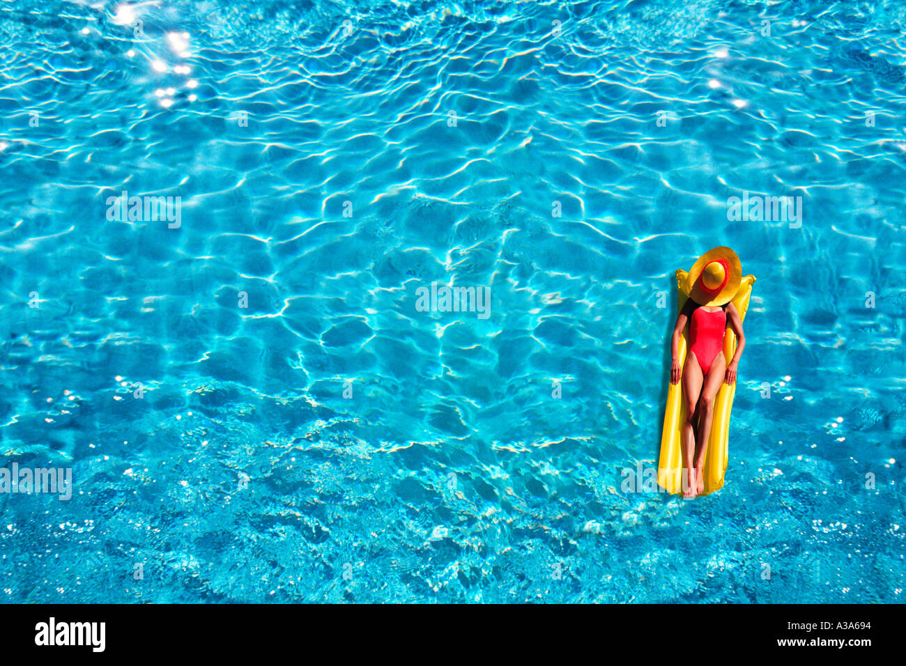 Woman Floating in Swimming Pool Stock Photo Alamy