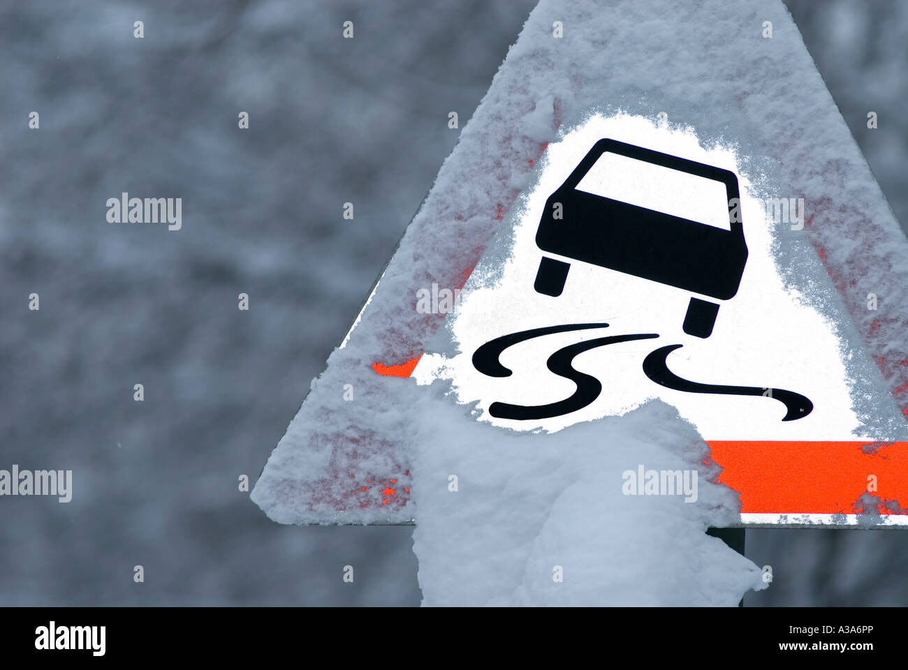 warning sign slippery road in winter germany Stock Photo
