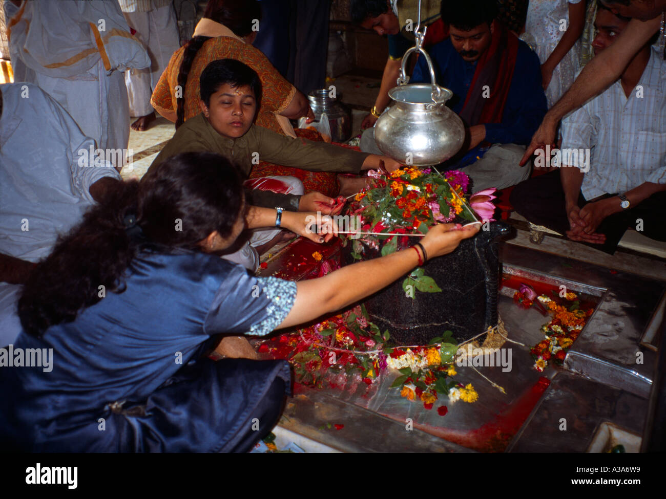 Mumbai (Formerly Bombay ) India Tying Sacred Thread Round Lingum Shiva Temple Shri Babulnath - Worship Hindu Stock Photo
