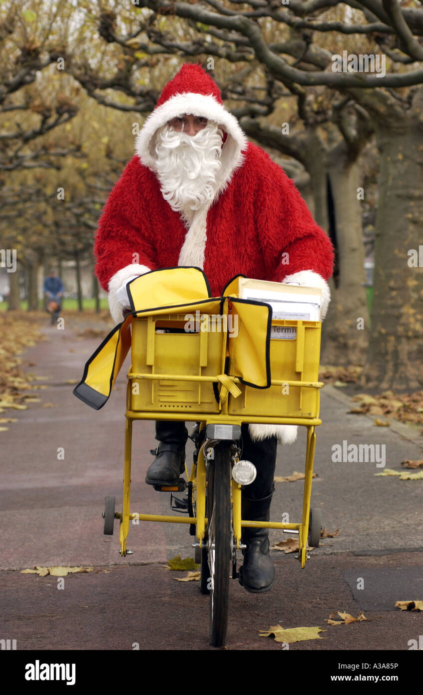 Santa Claus on a loaded bicycle Stock Photo