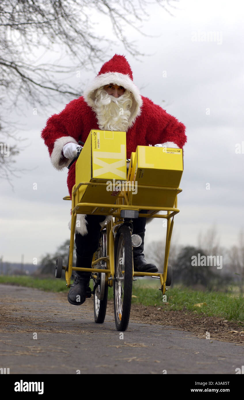 Santa Claus on a loaded bicycle Stock Photo