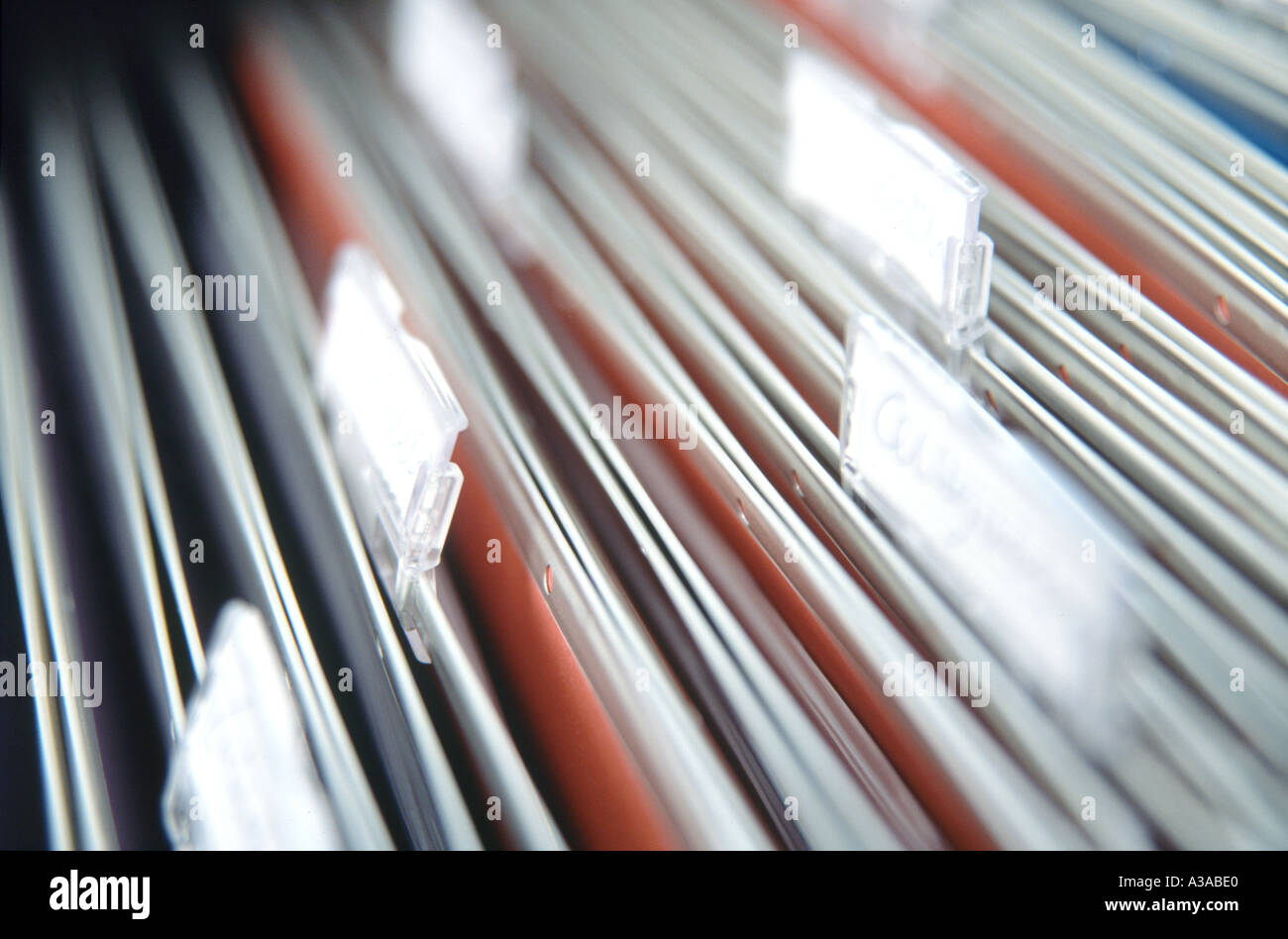 Old fashioned suspension files with title labels, hanging in a filing cabinet. Stock Photo