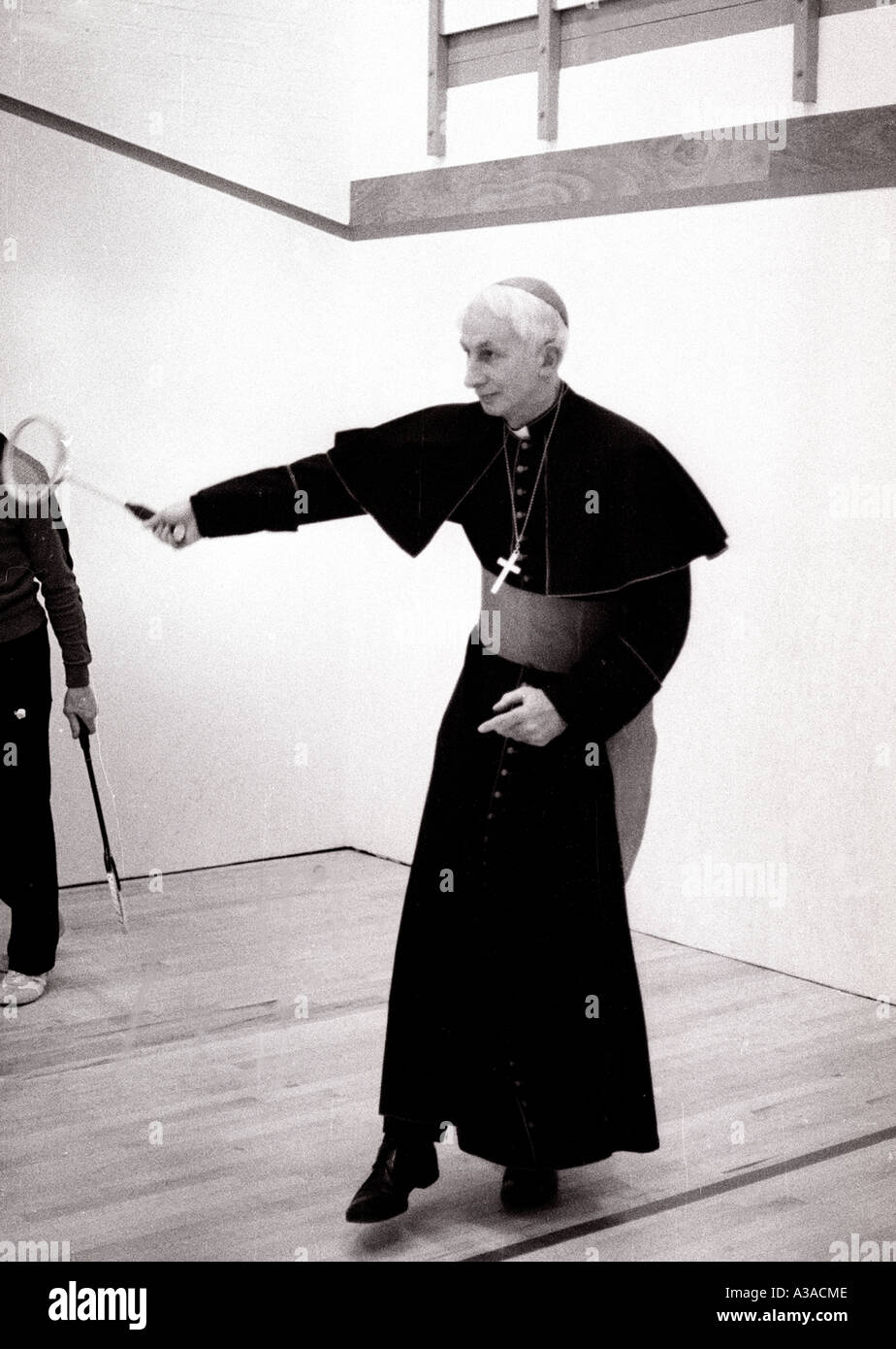 Cardinal Basil Hume Archbish of Westminster London UK plays squash during a school visit Stock Photo