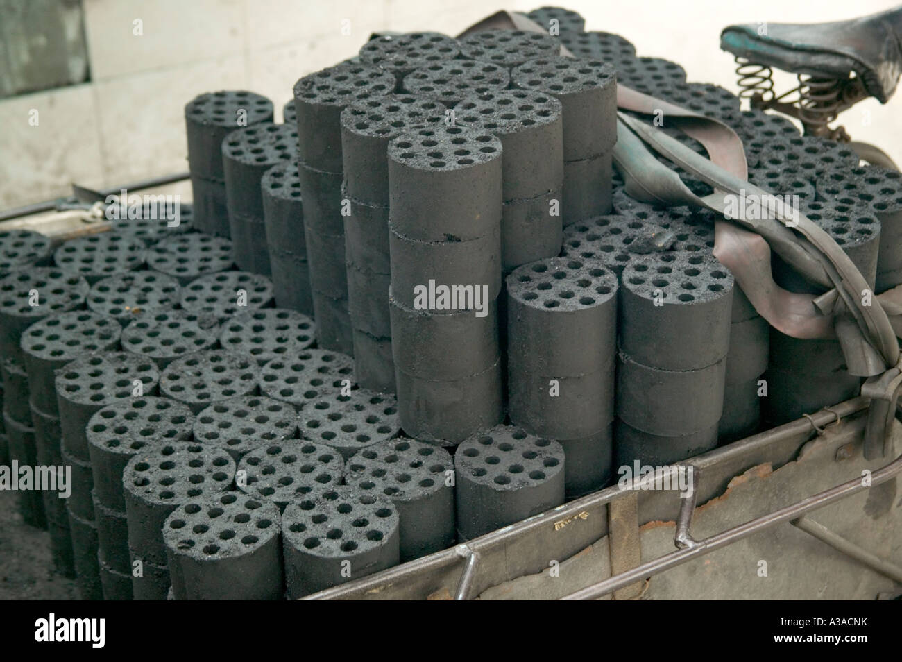 Coal dust compressed bricks loaded on bicycle cart Stock Photo