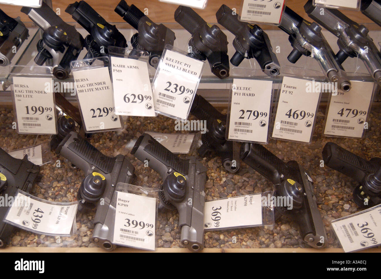 Gun Locks on Handguns In Display Case Stock Photo