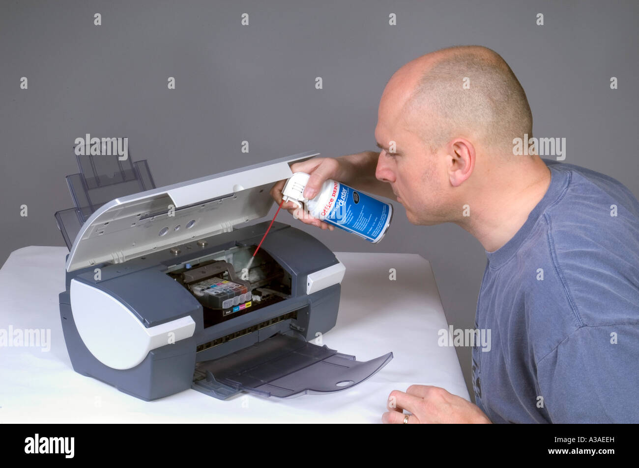 Man Cleaning Computer Printer With Compressed Air 5 Stock Photo Alamy