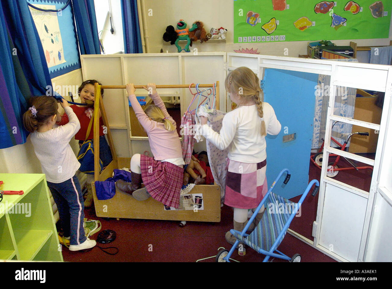 nursery school children in home corner play acting Stock Photo Alamy