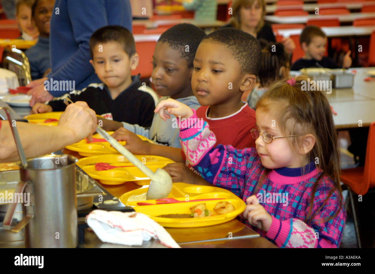 nursery school chidlren being served a school dinner Stock Photo