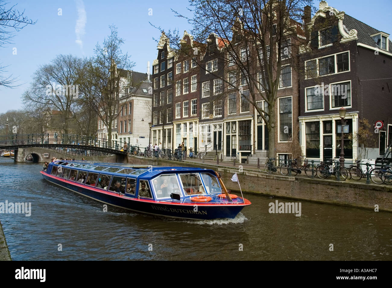 A water bus bring sightseers along one of the canals in Amsterdam Stock Photo