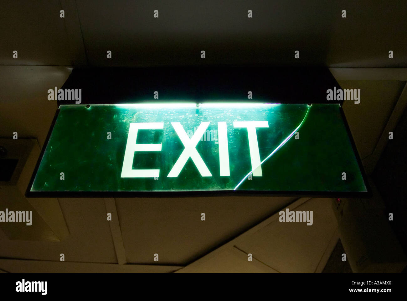 Illuminated green exit sign Stock Photo - Alamy