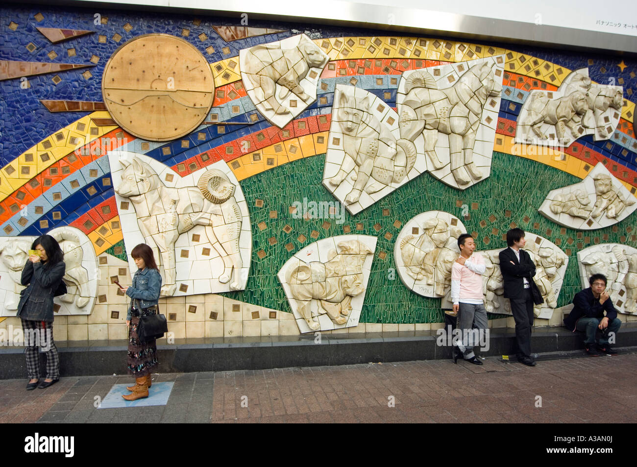 people waiting by Hachiko Dog wall mural Shibuya Tokyo Japan Asia Stock Photo